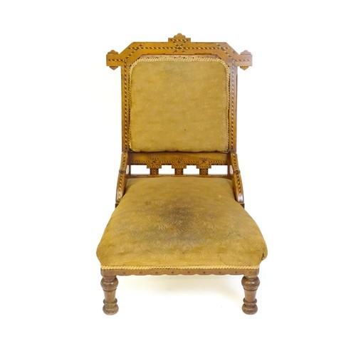 87 - A late 19thC walnut chair with checkered inlaid detail, shaped mouldings and a sprung seat above tur... 