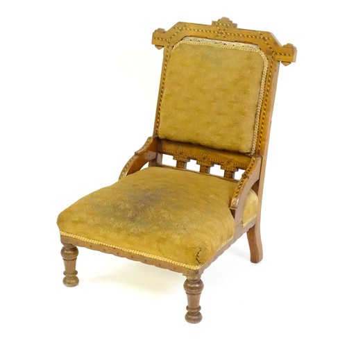 87 - A late 19thC walnut chair with checkered inlaid detail, shaped mouldings and a sprung seat above tur... 