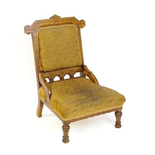 87 - A late 19thC walnut chair with checkered inlaid detail, shaped mouldings and a sprung seat above tur... 