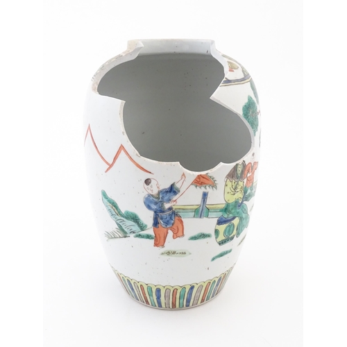 101 - A Chinese famille verte vase decorated with figures in a garden with banded borders. Approx. 11 3/4