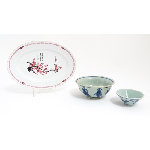 105 - Three Oriental items comprising a blue and white bowl decorated with the eight immortals, a sake bow... 