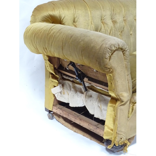 180 - A Victorian two seater button back sofa, with drop-end mechanism to each arm. Measuring approx 68