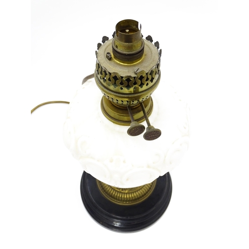 219 - A table lamp formed from a converted Veritas oil lamp with white / milk glass reservoir. Approx. 15