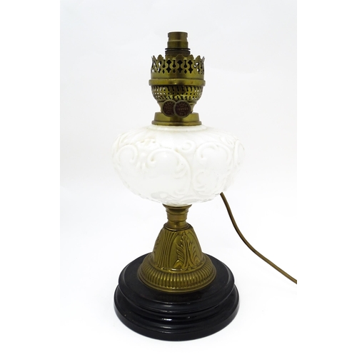 219 - A table lamp formed from a converted Veritas oil lamp with white / milk glass reservoir. Approx. 15