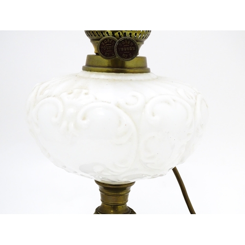 219 - A table lamp formed from a converted Veritas oil lamp with white / milk glass reservoir. Approx. 15