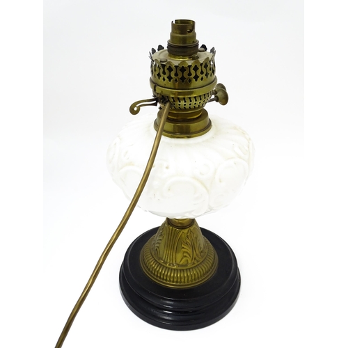 219 - A table lamp formed from a converted Veritas oil lamp with white / milk glass reservoir. Approx. 15