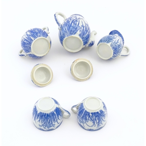 246 - A quantity of Oriental blue and white tea wares decorated with iris flowers and foliage, to include ... 