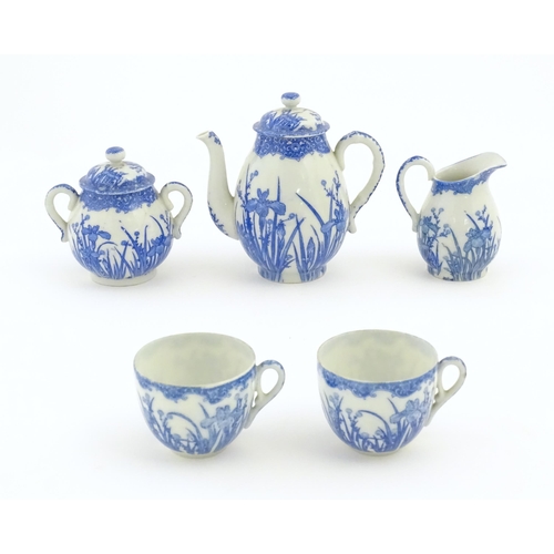 246 - A quantity of Oriental blue and white tea wares decorated with iris flowers and foliage, to include ... 