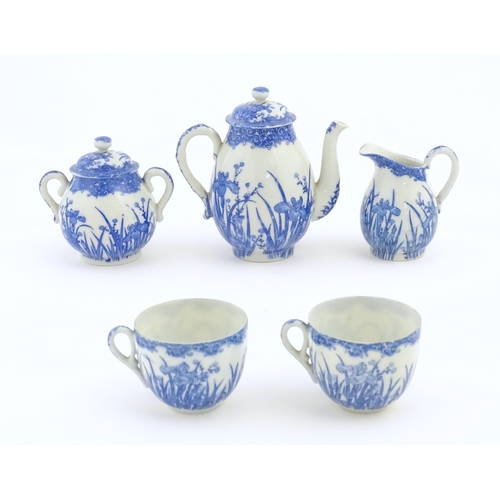 246 - A quantity of Oriental blue and white tea wares decorated with iris flowers and foliage, to include ... 