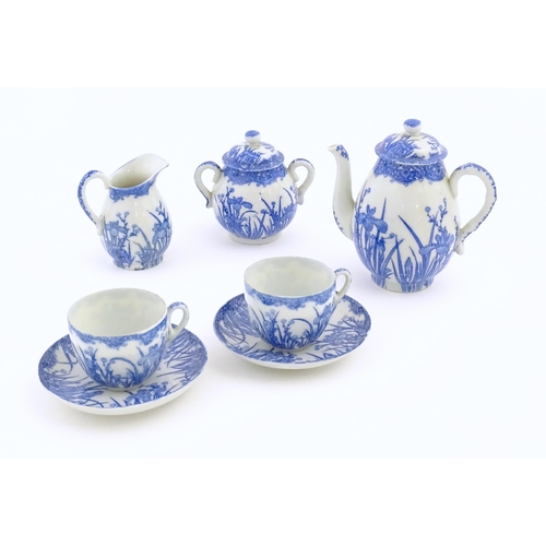 246 - A quantity of Oriental blue and white tea wares decorated with iris flowers and foliage, to include ... 