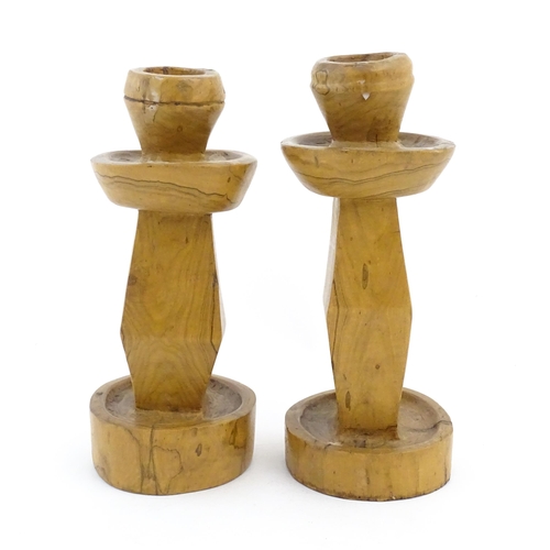 323 - A pair of naive carved fruitwood candlesticks. Approx. 11 1/2