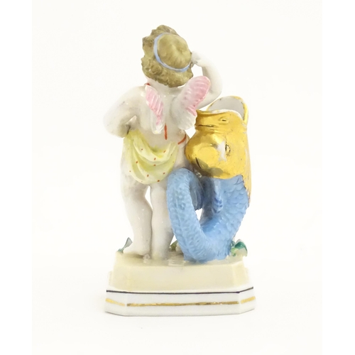 398 - A Continental figure modelled as a putti resting on a Georgian dolphin. Marked under with initials f... 