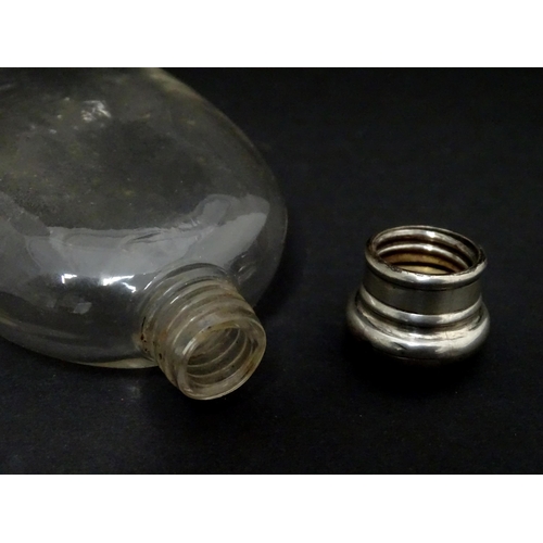 422 - A glass hip flask of ovoid form with screw top. Approx. 4 3/4