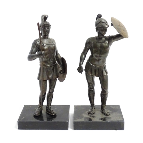 489 - Two 20thC cast sculptures depicting centurion soldiers with helmets and shields. Approx. 7