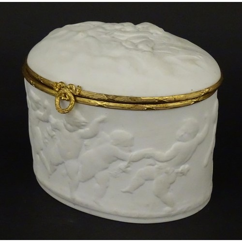 498 - A Limoges parian ware oval box with a hinged lid, decorated in relief with dancing putti / cherubs. ... 