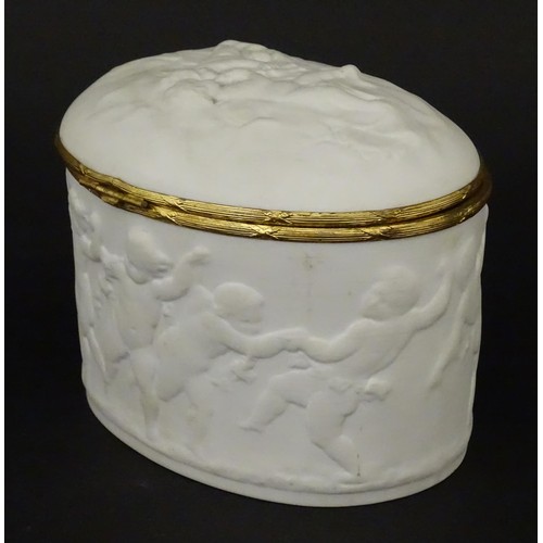 498 - A Limoges parian ware oval box with a hinged lid, decorated in relief with dancing putti / cherubs. ... 