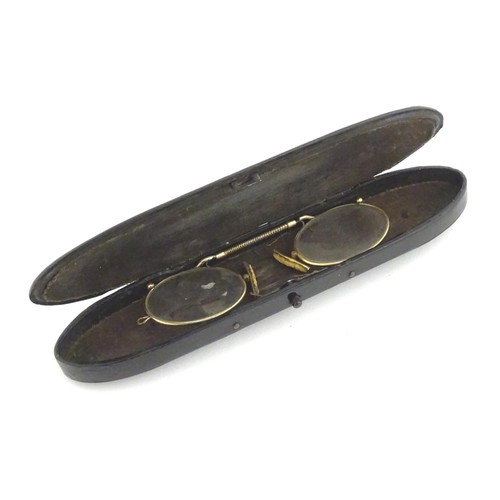 510 - A Victorian papier mache spectacle / glasses case with scrolling border. Together with a pair of gil... 