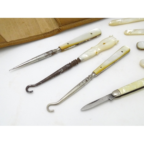 512 - A quantity of early 20thC mother of pearl / mother of pearl handled tools to include button hooks, s... 