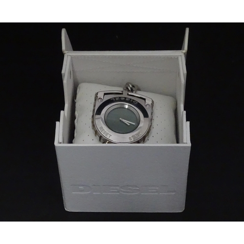 546 - A boxed Diesel watch / stopwatch on chain, approx 2