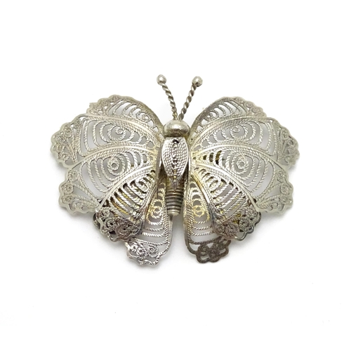 549 - A white metal filigree brooch formed as a butterfly together with three pairs of gilt metal earrings... 