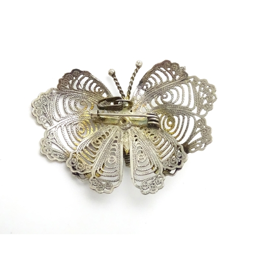 549 - A white metal filigree brooch formed as a butterfly together with three pairs of gilt metal earrings... 