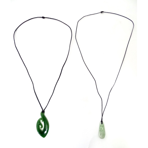 557 - A Jade coloured hardstone pendant together with another (2)