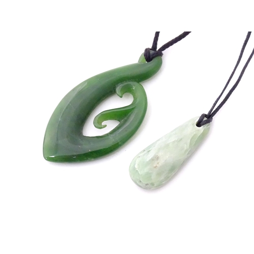 557 - A Jade coloured hardstone pendant together with another (2)