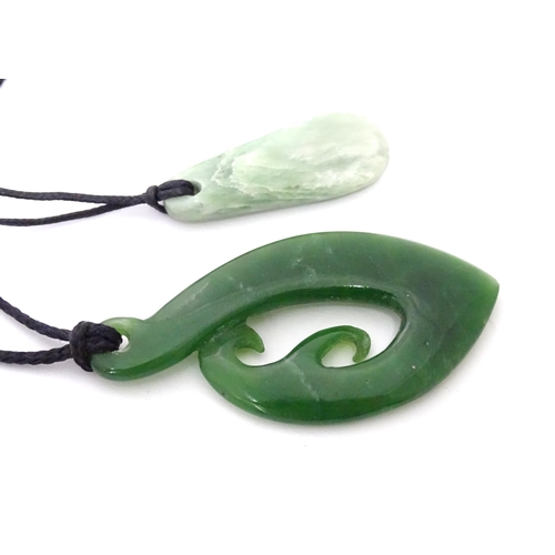 557 - A Jade coloured hardstone pendant together with another (2)