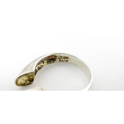 561 - A silver 'giving ring' with interchangeable central stones. Ring size approx. P.