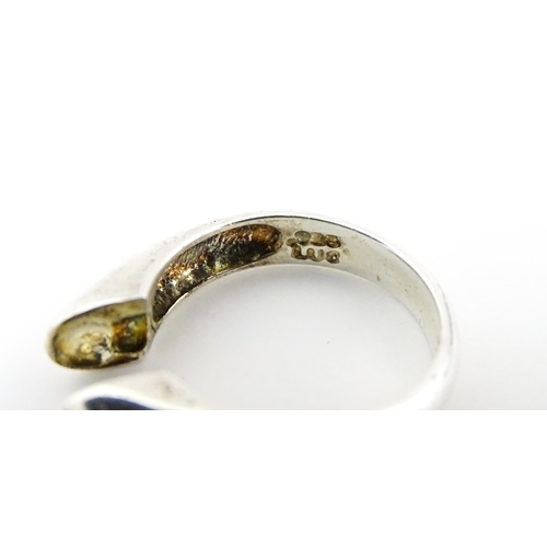 561 - A silver 'giving ring' with interchangeable central stones. Ring size approx. P.