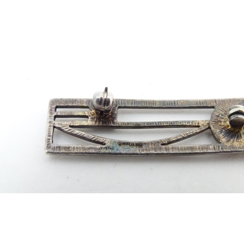 567 - A silver brooch inspired by the designs of Charles Rennie Macintosh, together with a brooch marked S... 