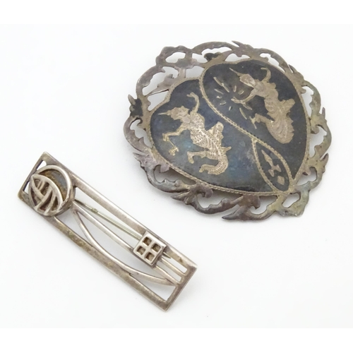 567 - A silver brooch inspired by the designs of Charles Rennie Macintosh, together with a brooch marked S... 