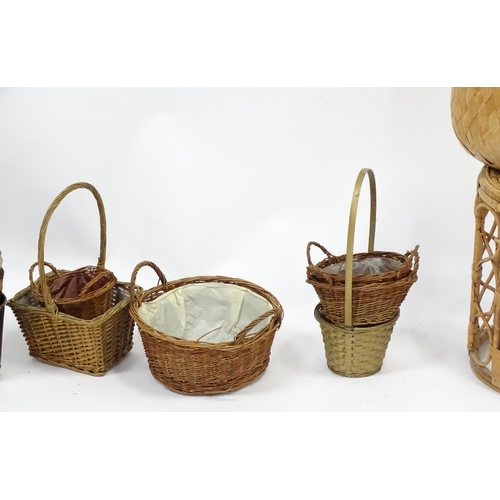 586 - A bamboo and rattan circular table together with a collection of wicker baskets, etc.