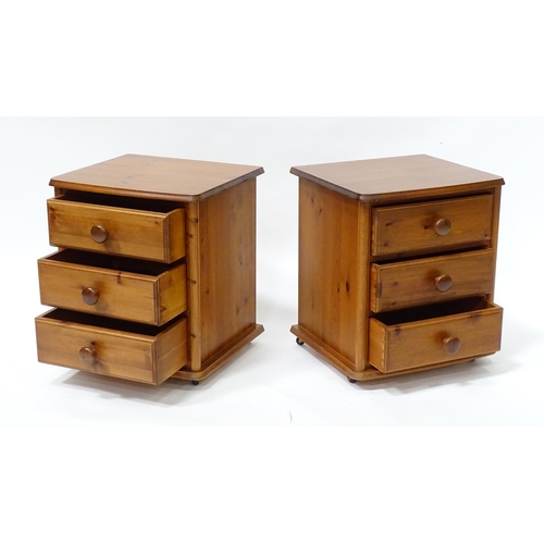 615 - A pair of pine bedside cabinets, each with three drawers with turned wooden handles. 18