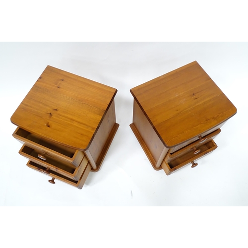 615 - A pair of pine bedside cabinets, each with three drawers with turned wooden handles. 18