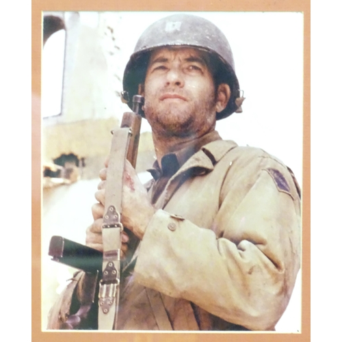 621 - A framed photograph of Tom Hanks from the movie Saving Private Ryan. Photograph approx. 9