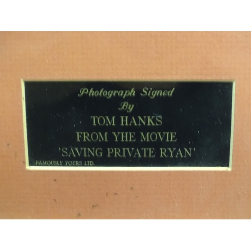 621 - A framed photograph of Tom Hanks from the movie Saving Private Ryan. Photograph approx. 9