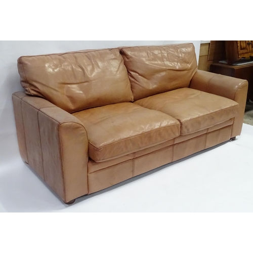 658 - A 20thc large two seat leather sofa, 78