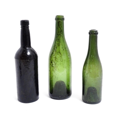 687 - Three 19thC glass wine bottles. Largest approx 12