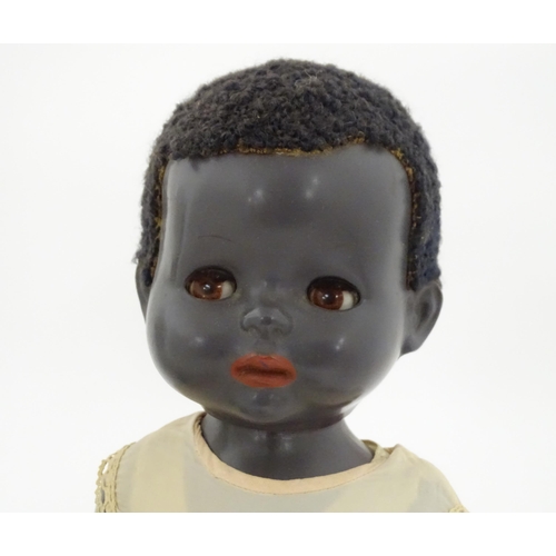 709 - Toys: Two 20thC plastic black dolls, to include an example by Pedigree with blinking eyes, painted l... 