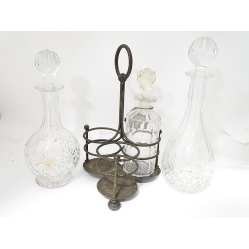 713 - Various glass decanters with a silver plate bottle stand and a silver plate decanter label. Largest ... 