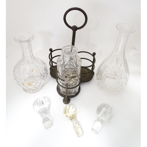 713 - Various glass decanters with a silver plate bottle stand and a silver plate decanter label. Largest ... 