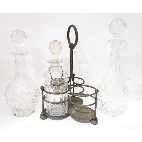 713 - Various glass decanters with a silver plate bottle stand and a silver plate decanter label. Largest ... 