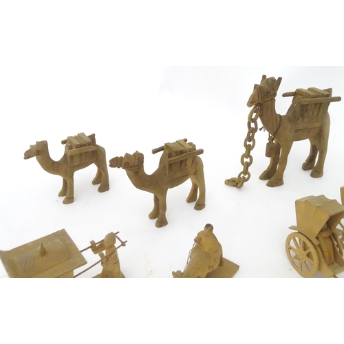 759 - A quantity of assorted carved wooden figures, animals, etc. to include graduated camels, water buffa... 