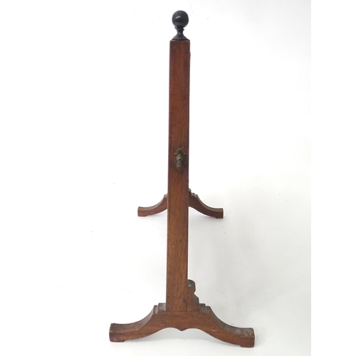 786 - A 19thC mahogany toilet mirror, the adjustable frame with rectangular glass supported by a fluted st... 