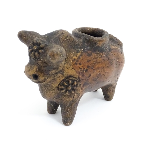 804 - Four assorted items comprising a terracotta model of a stylised bull with flower detail, a carved wo... 