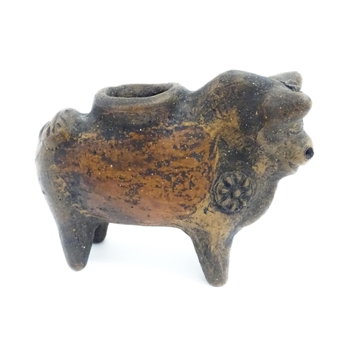 804 - Four assorted items comprising a terracotta model of a stylised bull with flower detail, a carved wo... 