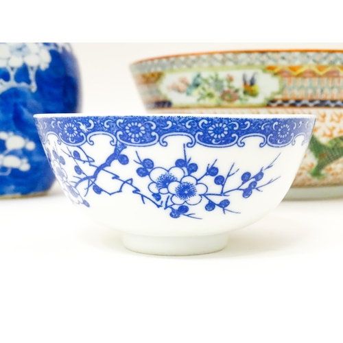 819 - Three Chinese items comprising a blue and white vase with prunus blossom, a bowl with dragon and sty... 