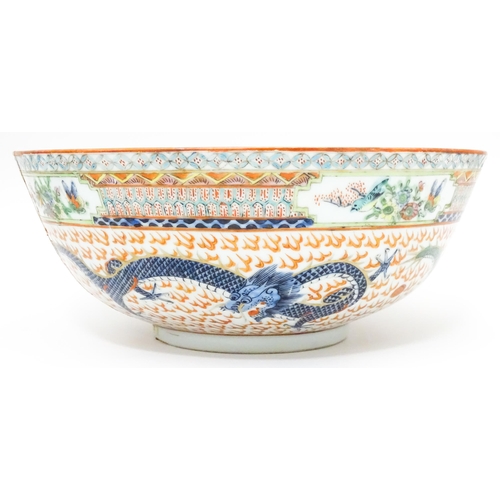 819 - Three Chinese items comprising a blue and white vase with prunus blossom, a bowl with dragon and sty... 