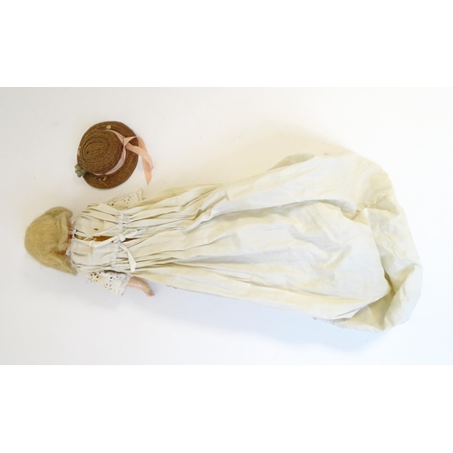 901 - Toy: A 20thC doll with wax head, glass eyes, painted features, composite arms and lower legs. Approx... 